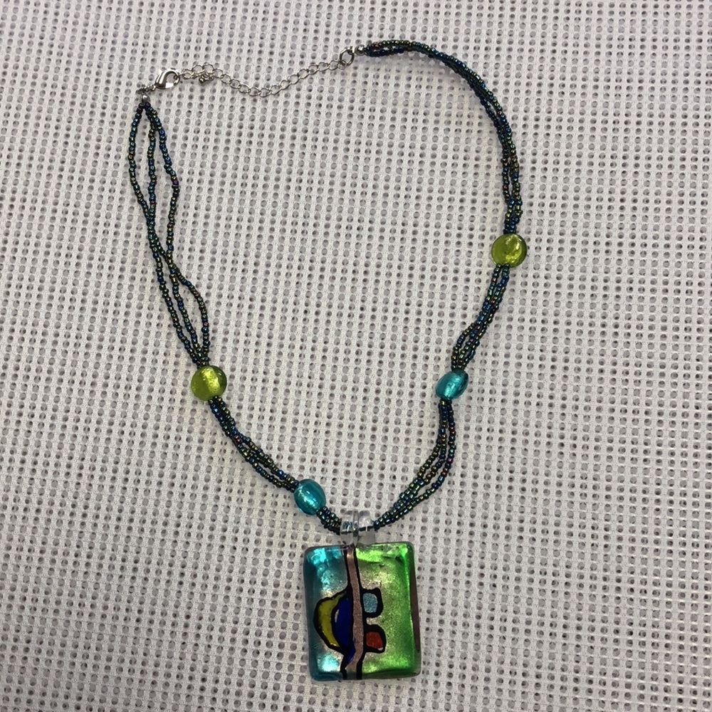 Brightly colored necklace with whimsical charm